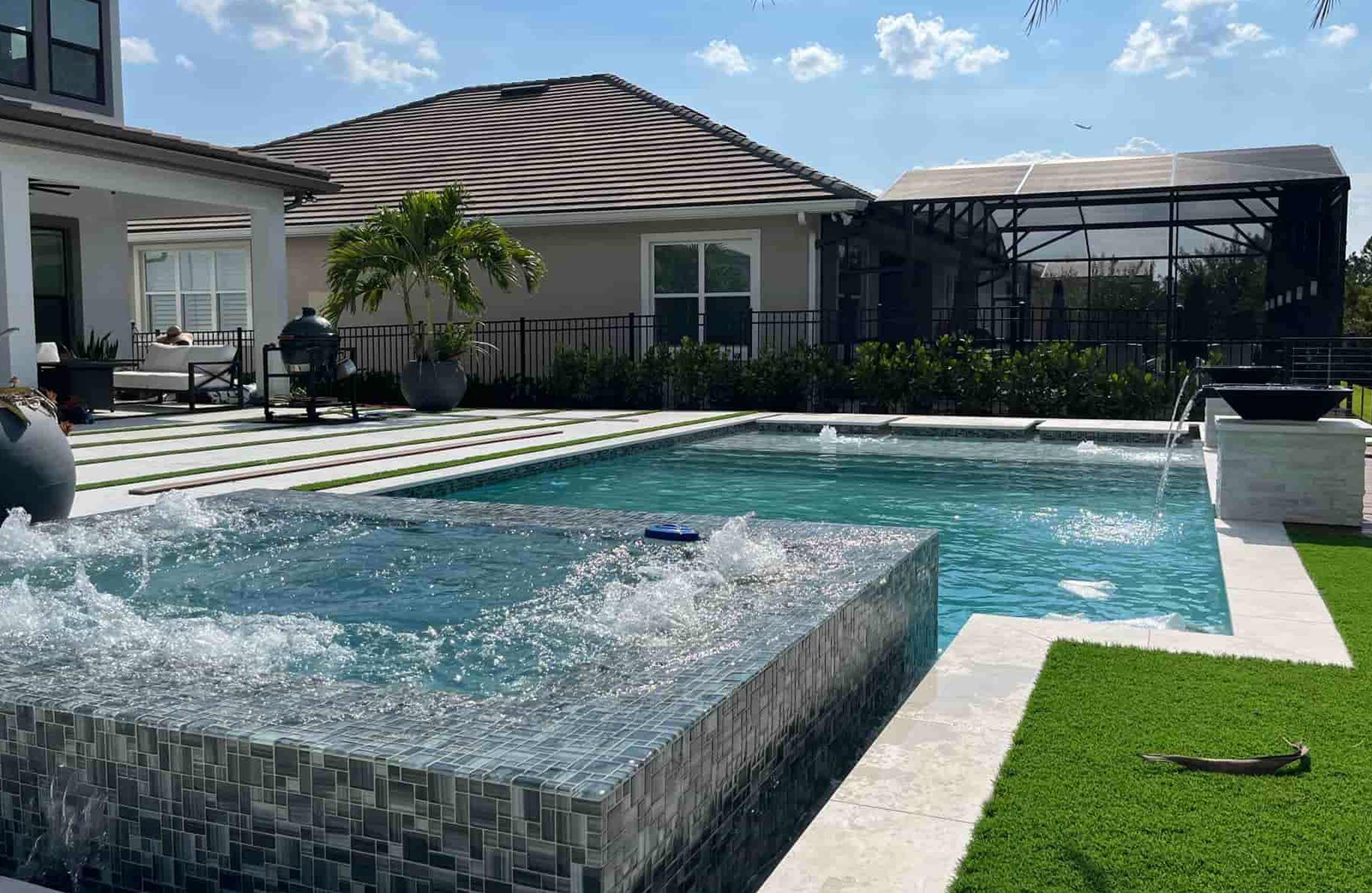 Raised spa and water features in a Grunit residential pool